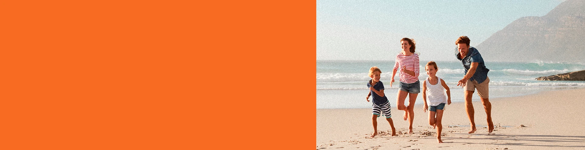A family running together on the beach