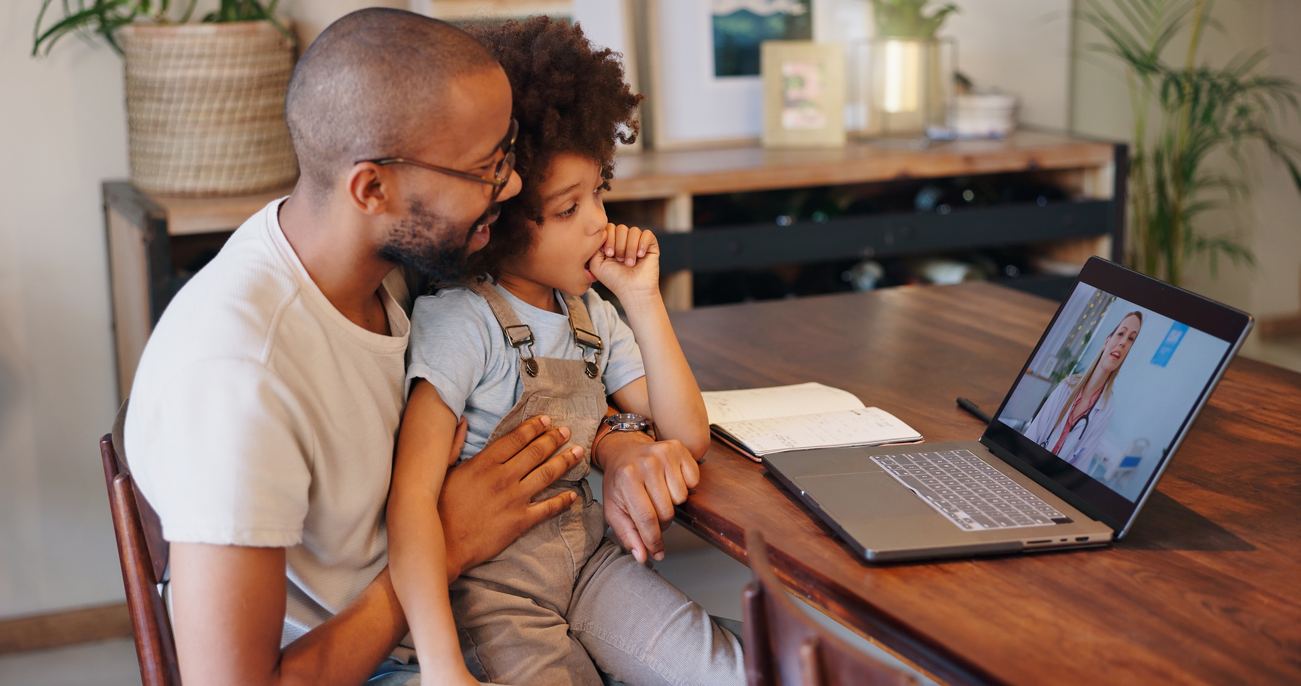Child, black man and laptop screen with doctor for telehealth service, communication and advice. Home, boy and father with pediatrician on tech for medical support, discussion or virtual consultation Child, black man and laptop screen with doctor for telehealth service, communication and advice. Home, boy and father with pediatrician on tech for medical support, discussion or virtual consultation