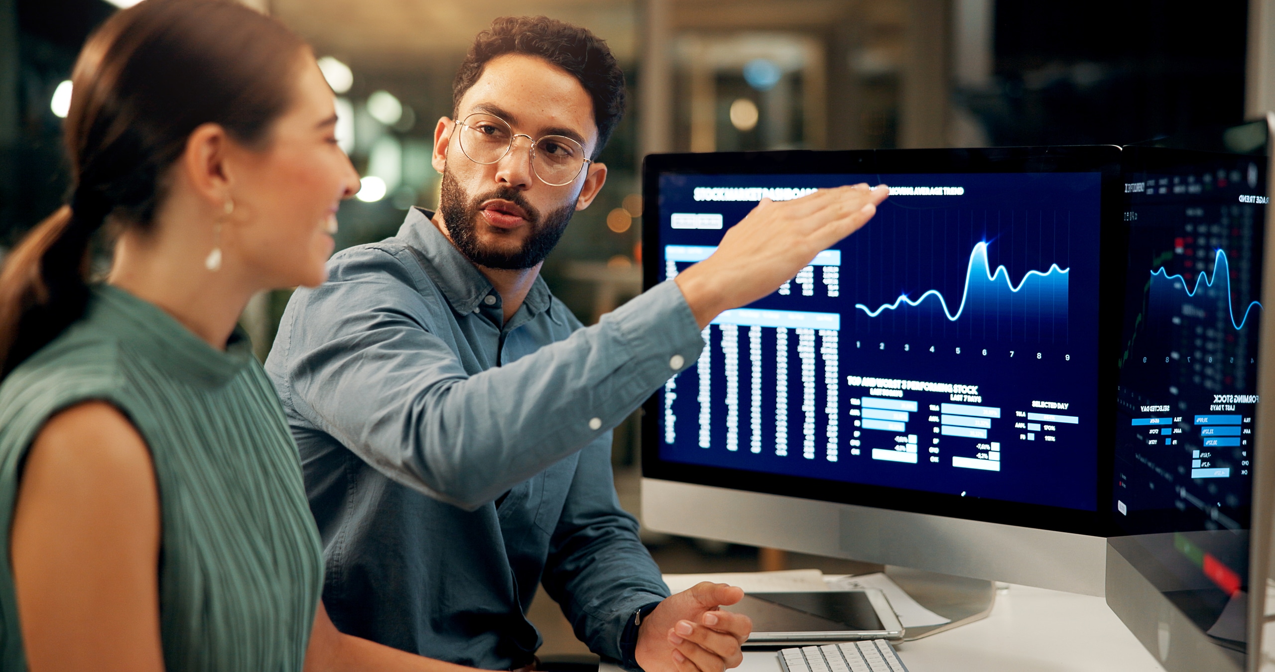 Business people, stock market and night with computer for profit, financial growth or increase at office. Businessman, woman or brokers with tech screen or display for online trading or investment Business people, stock market and night with computer for profit, financial growth or increase at office. Businessman, woman or brokers with tech screen or display for online trading or investment.