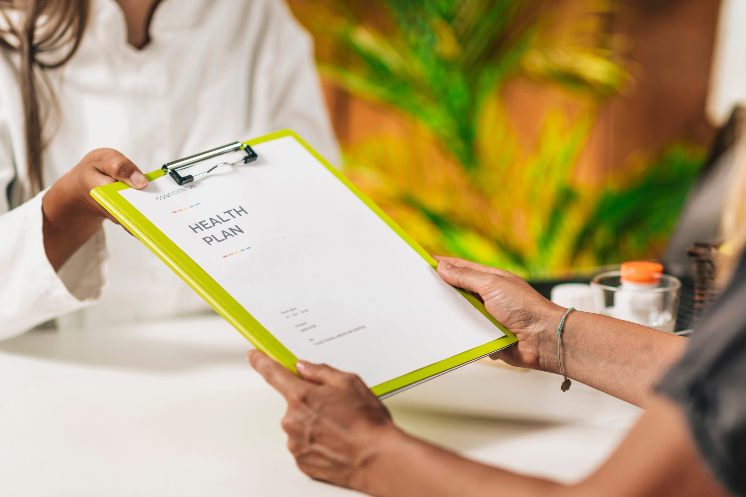 Preventive medicine, handing a personalized health plan to a client Preventive medicine, doctor handing a personalized health plan to a client