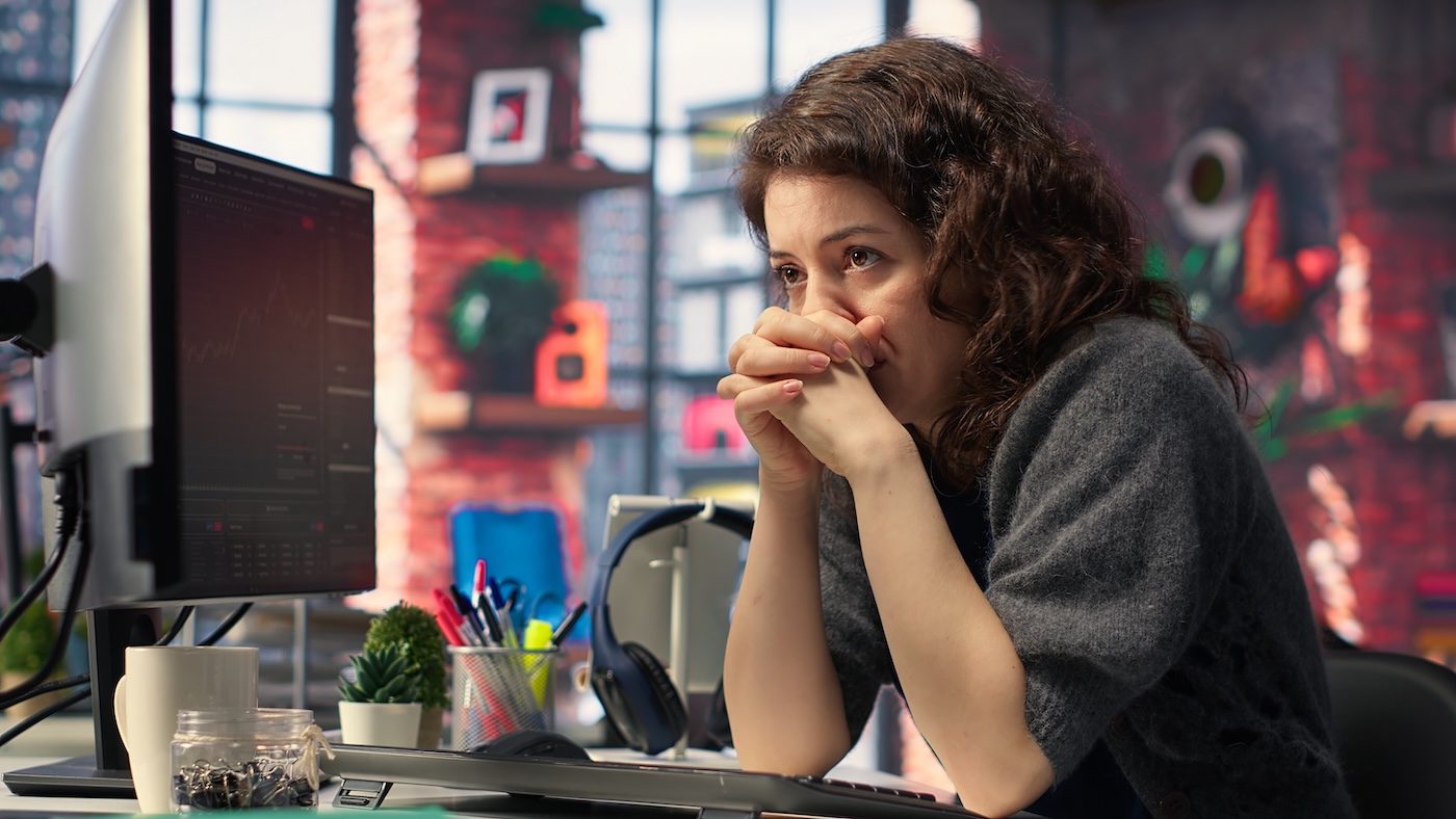 Devastated sad woman losing financial value on stock trading platform, crying and being stressed following market crash. Worried overwhelmed investor deals with monetary losses.