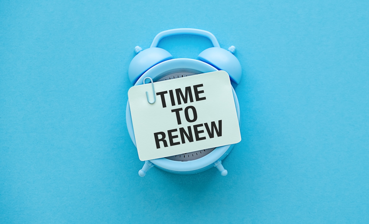 Image 2 Time to Renew text on bubble speech with alarm clock top view on blue background