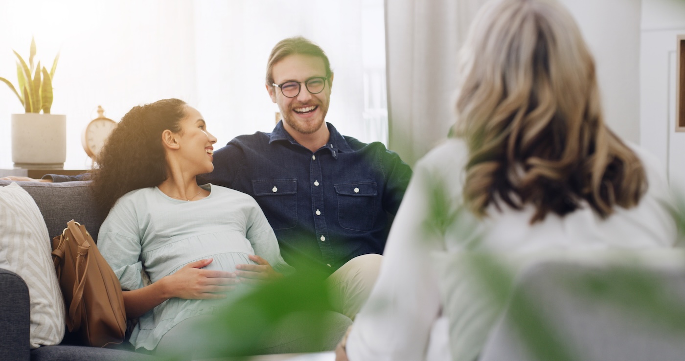 Counselling, happy couple and pregnant Counselling, happy couple and pregnant in therapist office for visit, advice and talk for help. Pregnancy, man and woman with psychologist for understanding, trust and therapy for support as parents.