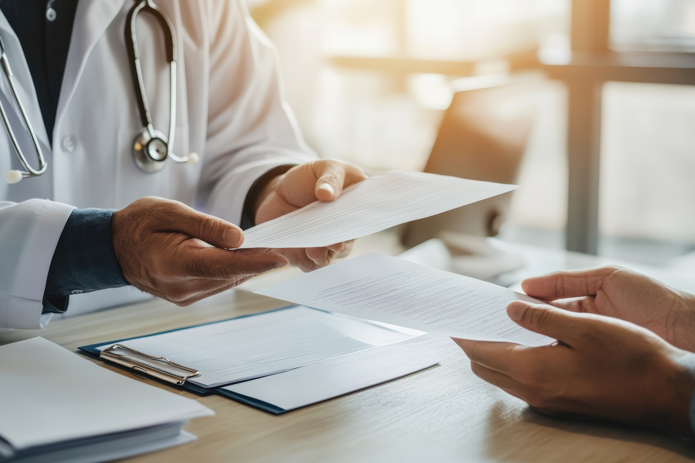 Image 3 Doctor handing health insurance claim form to patient in bright modern clinic office demonstrating healthcare administration billing process and medical insurance coverage discussion