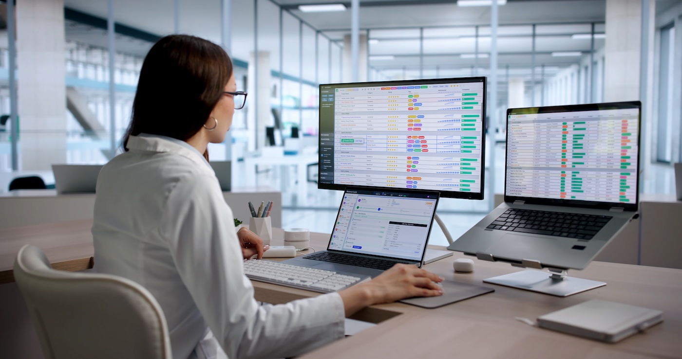 Young Woman Medical Coding Specialist Reviews Billing Data On Laptop Screen. Young Woman Medical Coding Specialist Reviews Billing Data On Laptop Screen
